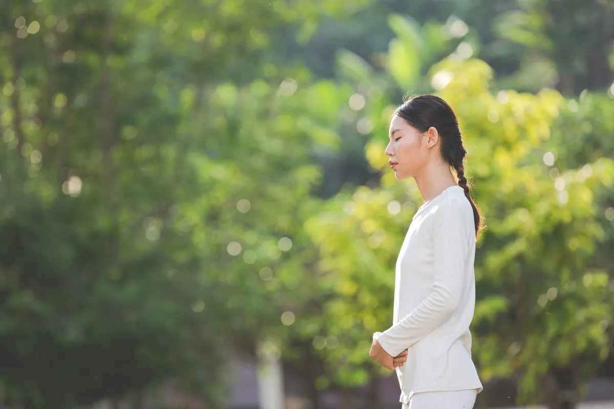 A woman breathing easily in clean, fresh outdoor air