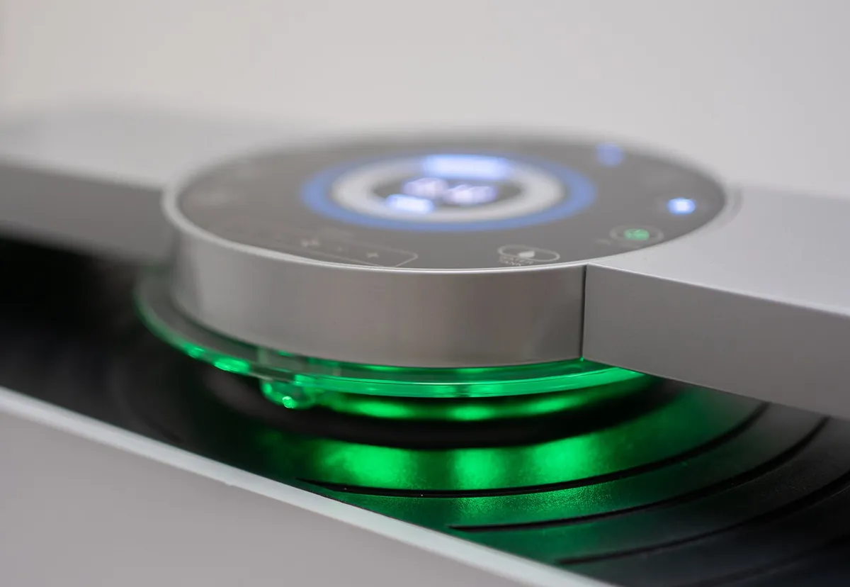 AIRE purifier core glowing green during an active sterilisation cycle